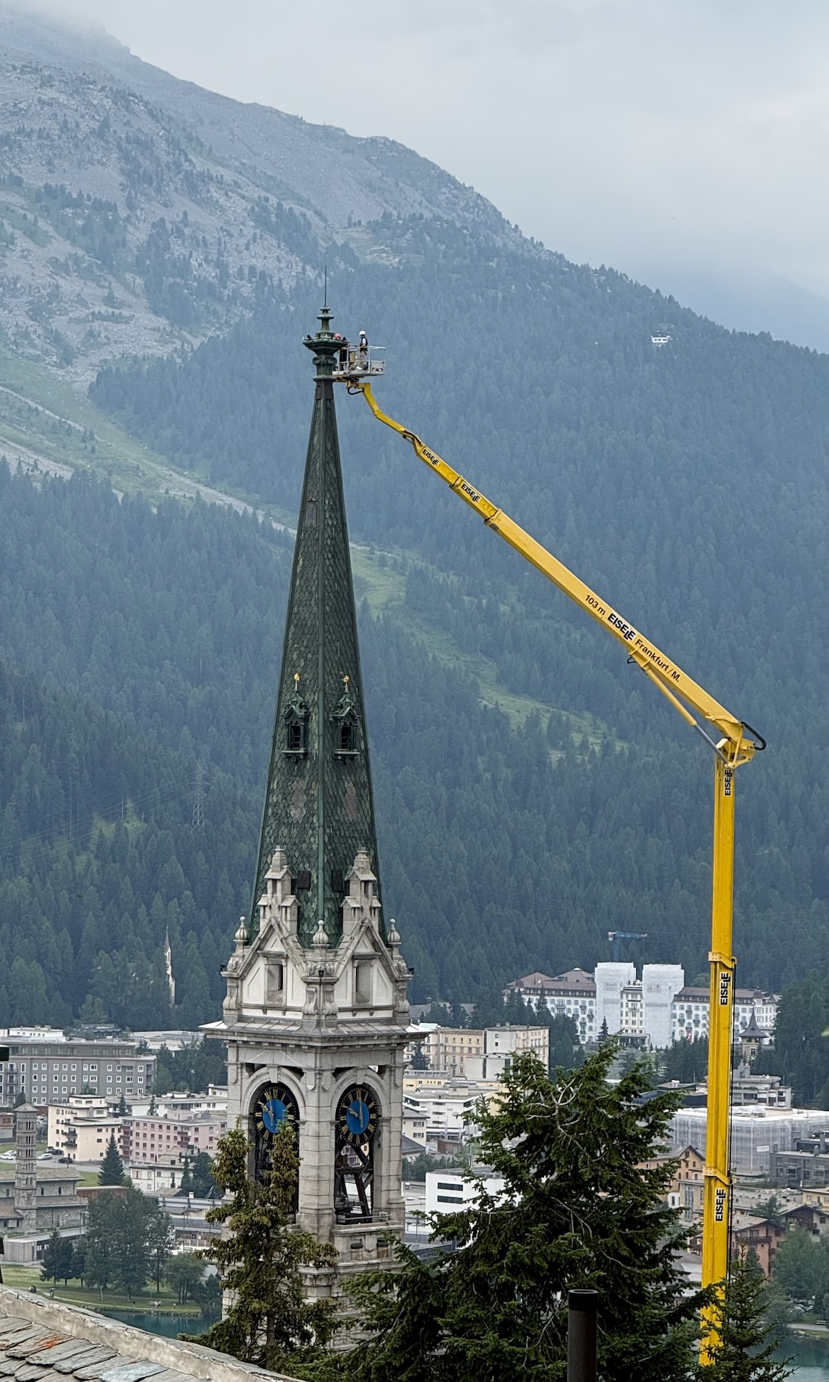 Cherry picker reaching the top of the church tower.