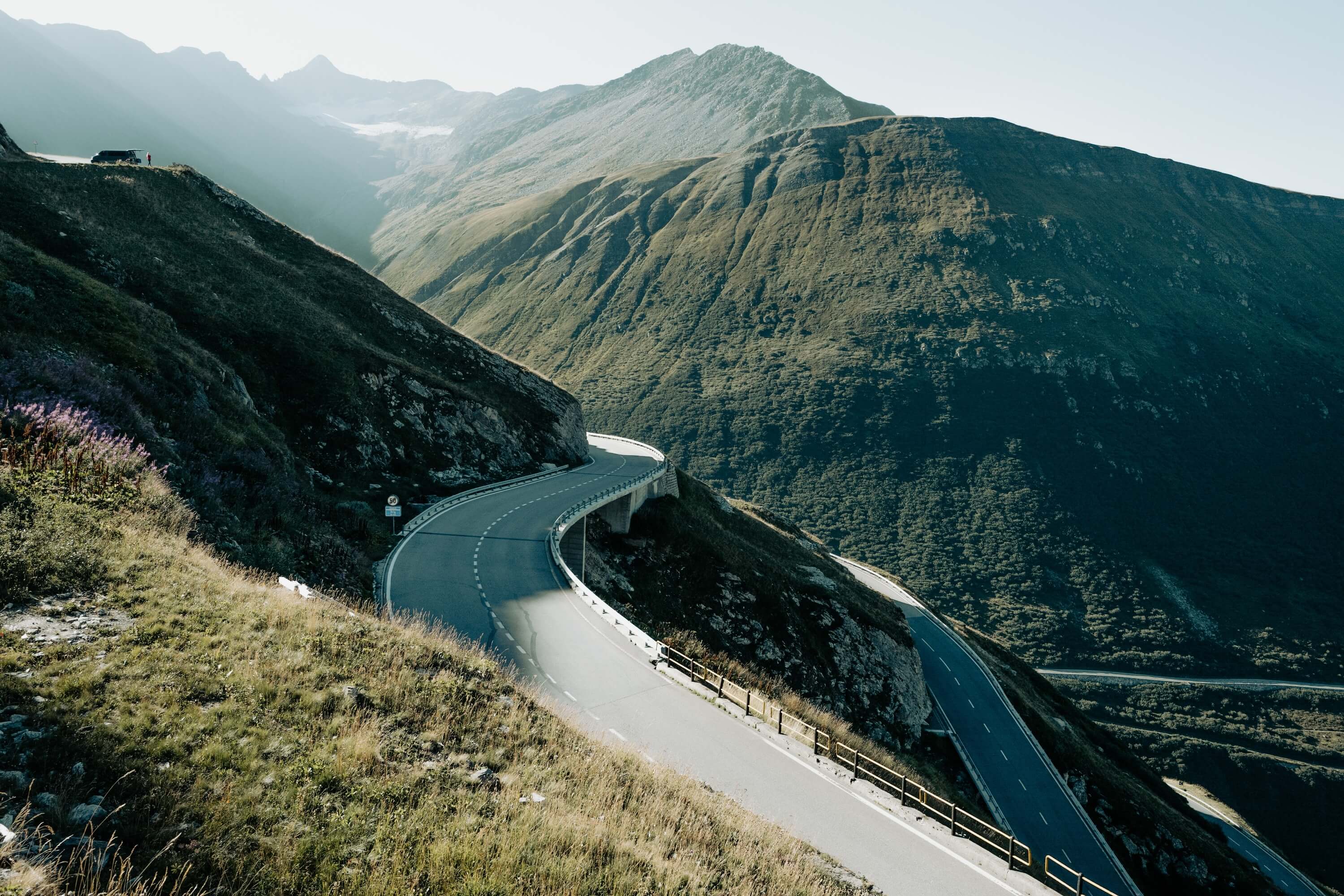 Camper van in the top corner of the photograph of the Furka Pass