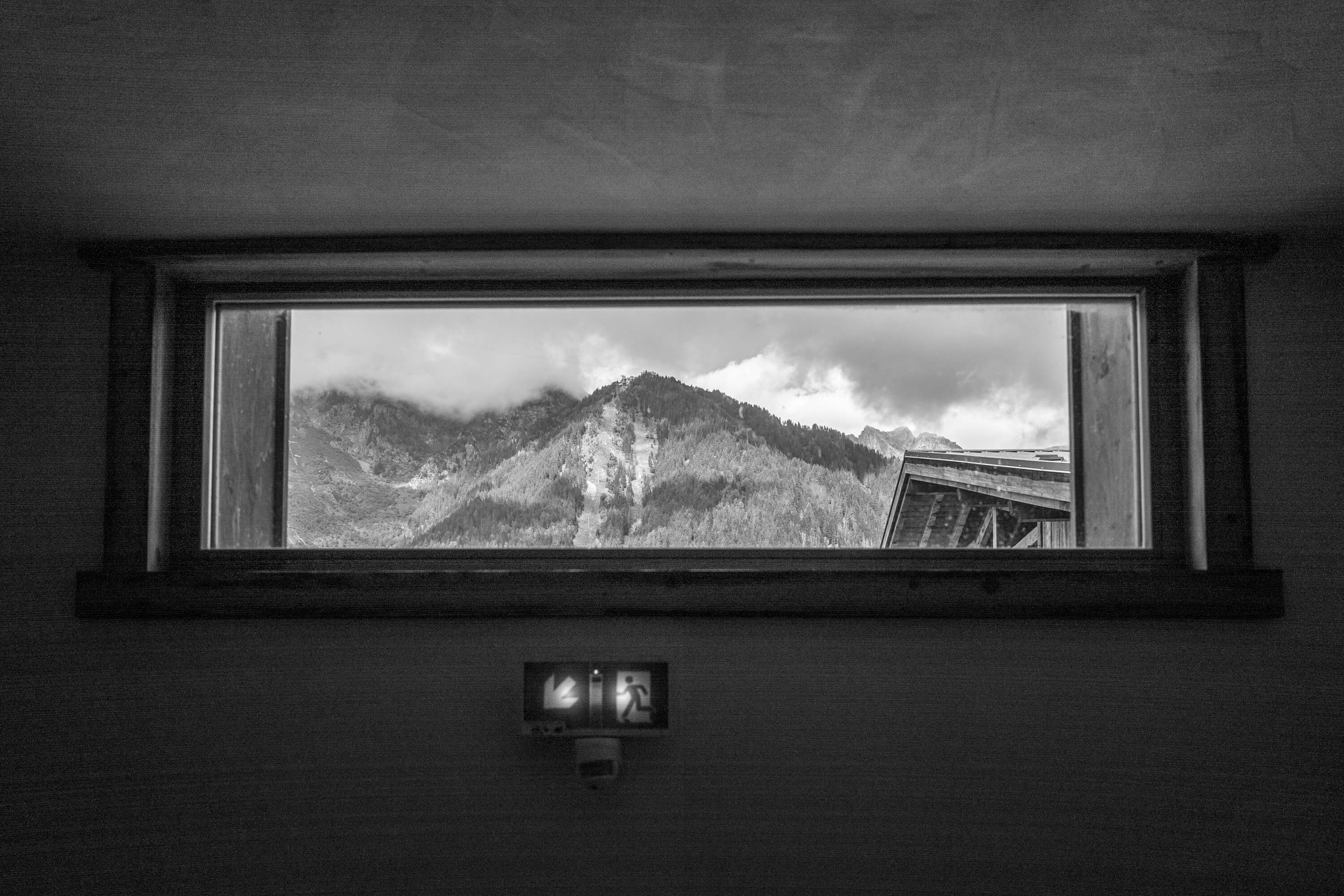 A high window gives a narrow glimpse of the Planpraz