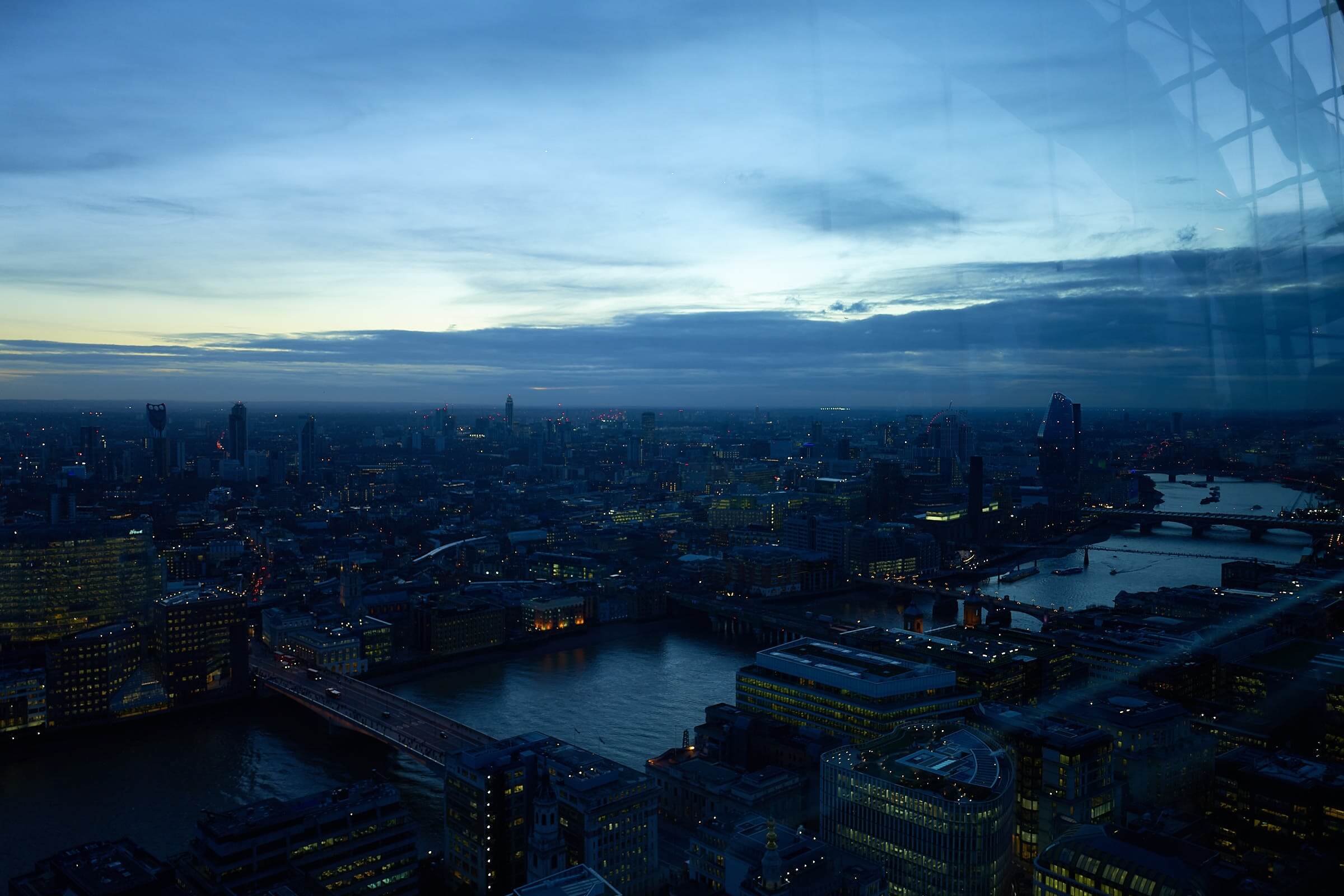 Millennium Bridge and Blackfriars Bridge over the River Thames with Heathrow Airport in the background.