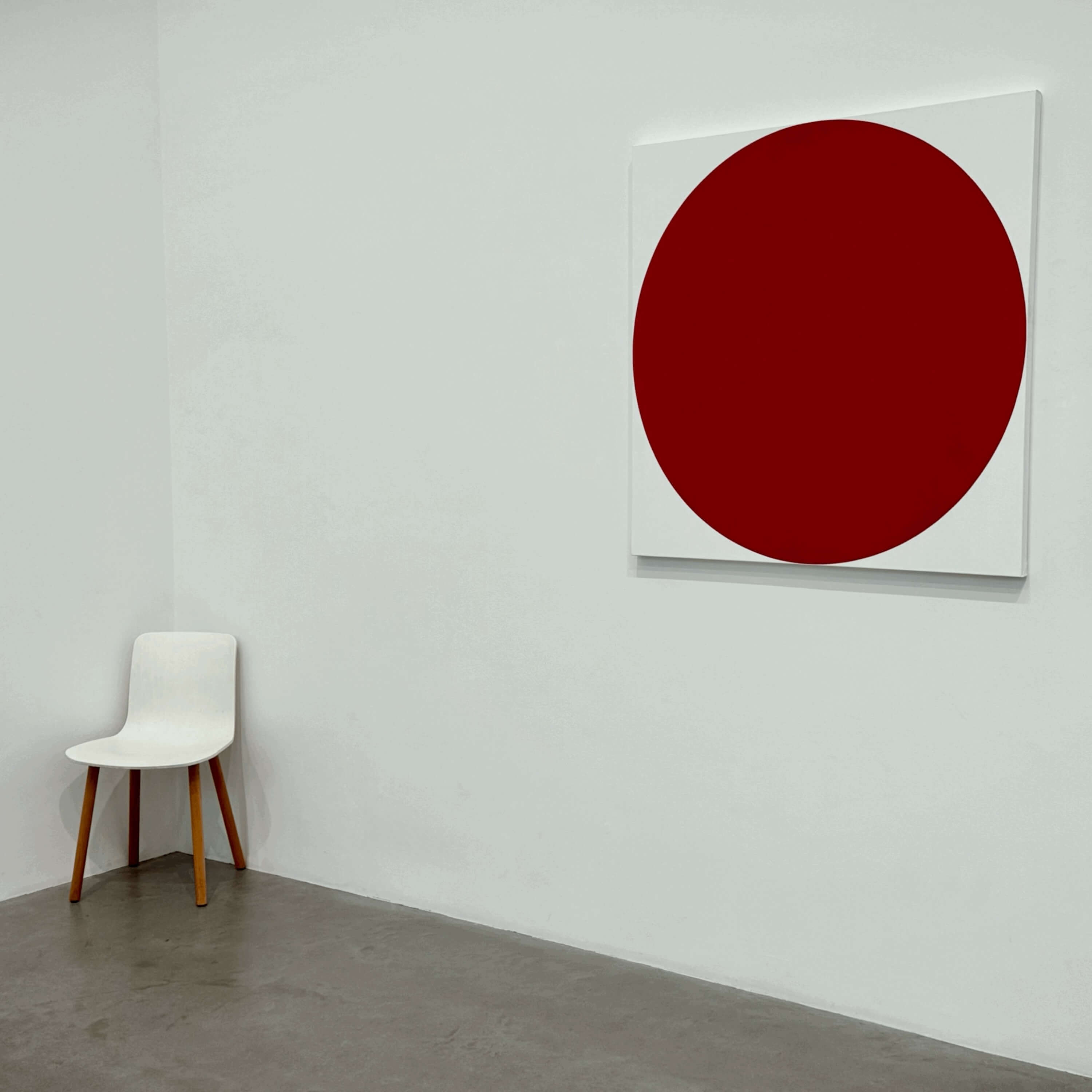 Red circle on white painting