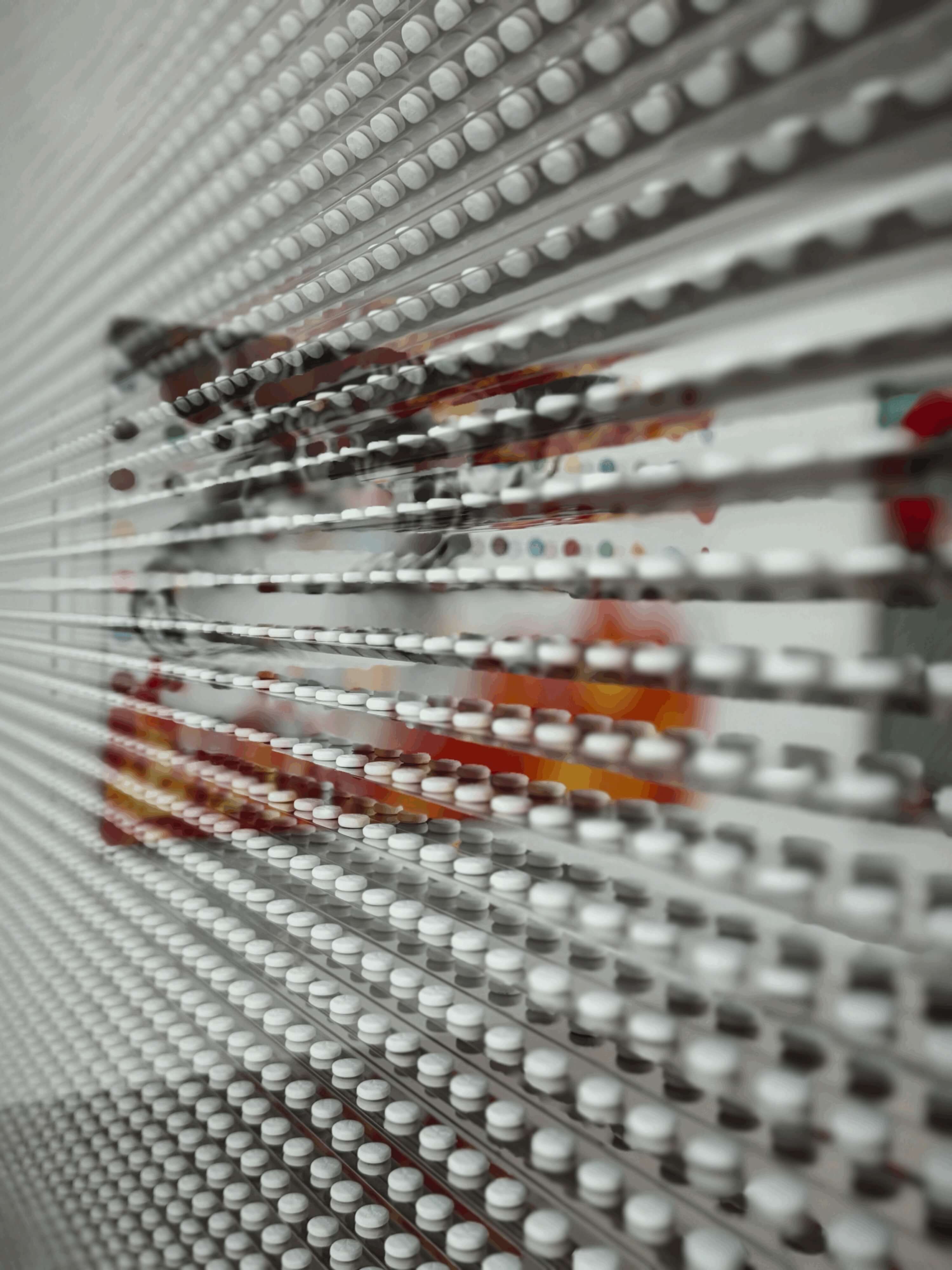 Damien Hirst-inspired pharmaceutical imagery within the exhibition